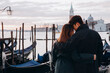 A romantic evening walk by a young Asian couple at the pier. A young couple travels to Venice.