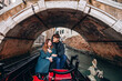 A romantic ride for a guy and a girl on a gondola through the canals of Venice. A young couple travels to Italy.
