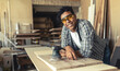 © BalanceFormCreative - Portrait of young black man carpenter in his workshop.