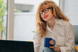 © carballo - woman at home with computer and cup of coffee