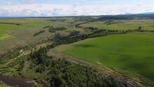 Idaho Farmland Creek River Valley Drone Shot Green Rolling Hills In Summer