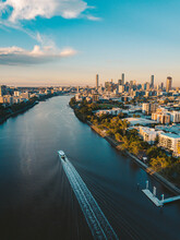 Sunset Aerial Shot Of Brisbane As A City Cat Heads Towards The City On The Brisbane River