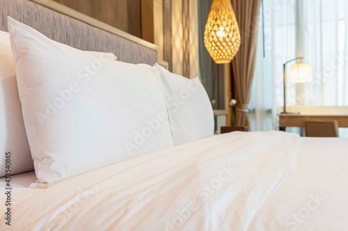 Clean white pillows are placed at the head of the bed in this elegant modern bedroom