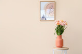Fototapeta Tulipany - Bouquet of beautiful tulip flowers on table near color wall