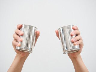 Closeup man hand holding metal can on white isolated background