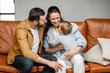 © rh2010 - Happy father, mother and little son are playing on sofa in living room. Child care and parenting.