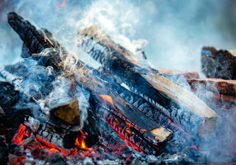 Close-up firewood, hot coals and ash. Lighting barbecue coals.