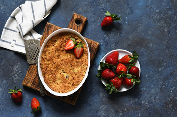 Wall Mural - Crumble with strawberries on a benton background. View from above.