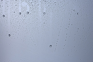 gray wet background / raindrops to overlay on the window, weather, background drops of water rain on the glass transparent