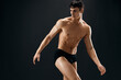 cute male athlete dark coward muscled body studio dark background