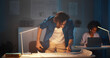 © TommyStockProject - Young male architect drawing blueprints in office late in evening