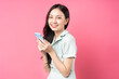 Young Asian woman holding phone to text