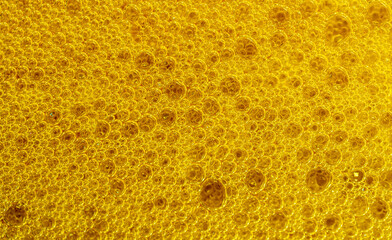 beer foam texture close up , porous ale bubble background macro , colored bar lager backdrop