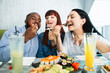 © sofiko14 - Young jolly multiracial friends eating sushi using chopsticks, looking positive and happy, sitting at asian restaurant and smiling. People, emotions, food and friendship concept