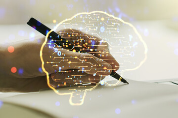 Wall Mural - creative artificial intelligence concept with human brain hologram and man hand writing in notebook 