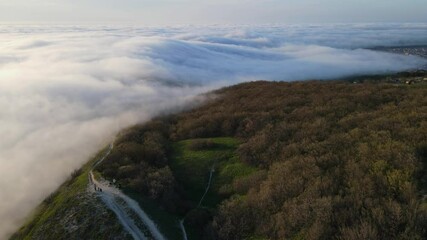 Wall Mural - Aerial view of creeping fog in evening. Foggy weather
