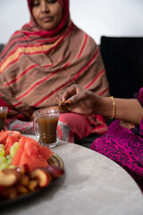 Two Black Muslim women having coffee together