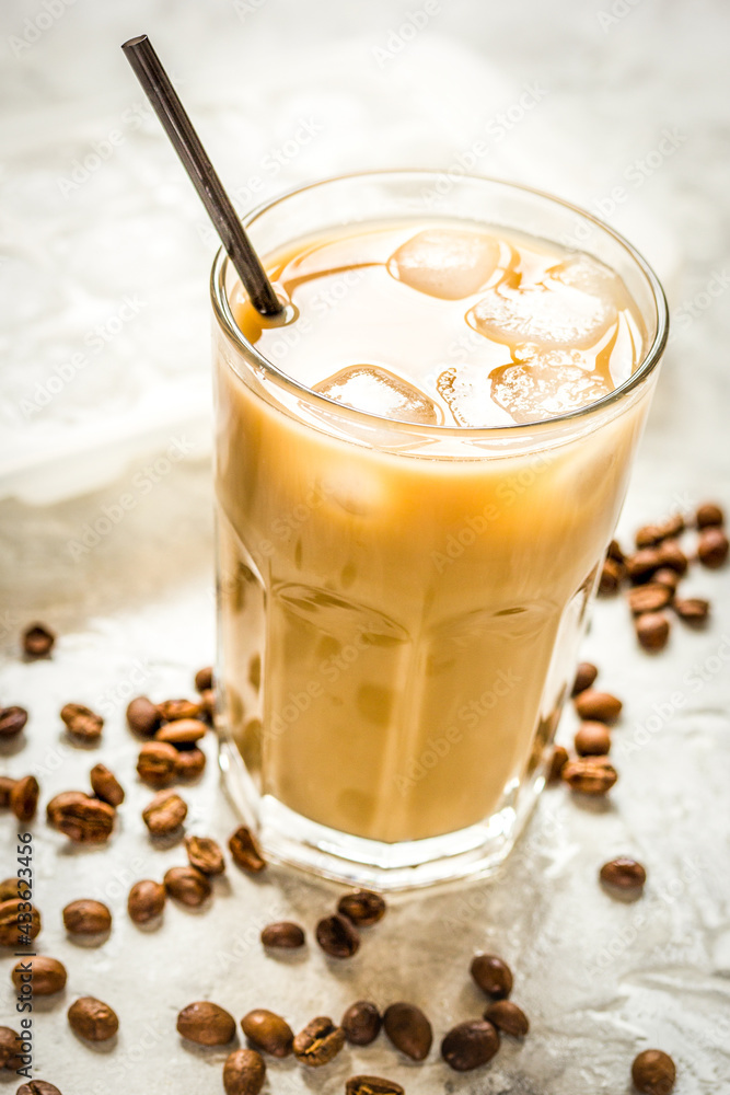 coffee ice cubes and beans with latte on stone desk background - obrazy, fototapety, plakaty 