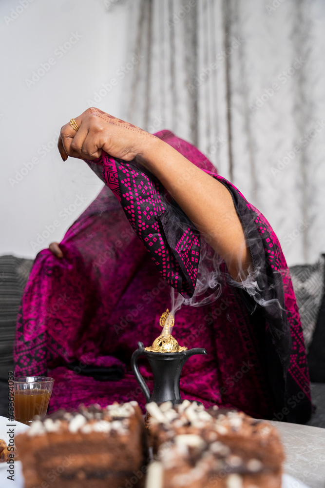 Black Muslim woman putting on incense Stock Photo | Adobe Stock