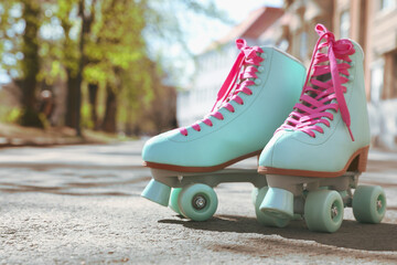 Wall Mural - stylish pink roller skates outdoors on sunny day. space for text