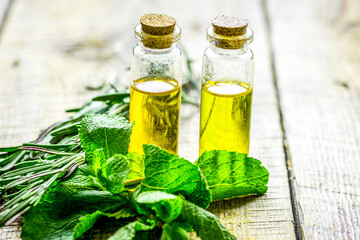 Wall Mural - homemade spa with herbal extract in oil on wooden table background