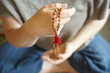 A  woman holding a mala yoga prayer bead necklace in her hand.
