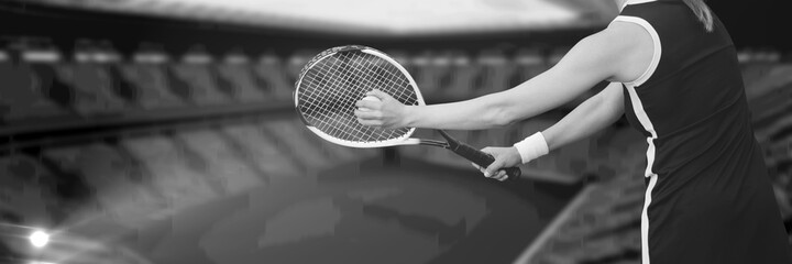 Wall Mural - Composition of midsection of woman playing tennis over sports stadium in black and white