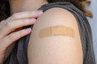© Petal Spirit - Close up on a female arm with a brown patch after vaccination for covid-19