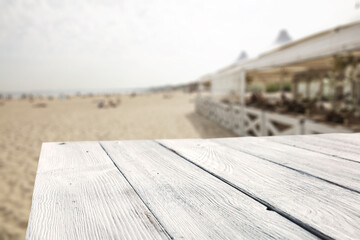 Sticker - Summer bar on beach and white wooden desk of free space for your decoration 