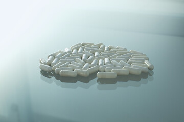 Wall Mural - White medical pills on glass table. Isolated