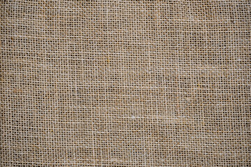 Wall Mural - Hessian sackcloth burlap woven texture background, Cotton woven fabric close up with flecks of varying colors of beige and brown, with copy space for text decoration.