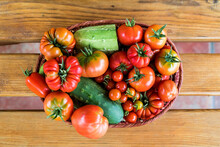 Top View Of A Tray Full Of Tomatoes And Cucumbers On The Wooden Table