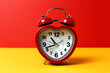 © Eduardo Lopez/ADDICTIVE STOCK - Red metal alarm clock in shape of heart placed on vibrant two colored background in studio