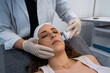© Enrique Espinosa/ADDICTIVE STOCK - Crop unrecognizable cosmetologist doing ultrasonic face peeling for relaxed woman lying on medical table in modern beauty clinic