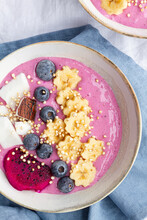 From Above Of Power Bowl Full Of Tasty Smoothie Near Ripe Banana And Dragon Fruit Slices With Blueberries For Breakfast