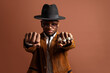 © Luis Manuel Munoz/ADDICTIVE STOCK - Young ethnic male in hat and stylish wear looking at camera on brown background