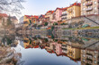 © Nacho Garin/ADDICTIVE STOCK - Picturesque view of aged shabby residential buildings reflecting in calm water of river