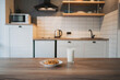 © Miguel Palomo/ADDICTIVE STOCK - Plate with tasty oatmeal biscuits with chocolate chips against glass of milk on wooden table