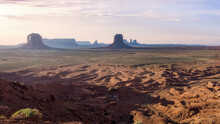 Spectacular Scenery Of Tall Rocky Formations Located In Monument Valley In America Under Colorful Sky At Sunset