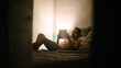 © Pere Nadal/ADDICTIVE STOCK - Nude male relaxing on comfortable bed and reading interesting book in bedroom in evening