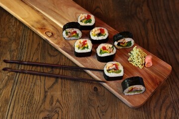 hot roll set sashimi japanese food on wooden background with lemon and chopsticks