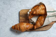 © Pempki/ADDICTIVE STOCK - Freshly baked croissants served on wooden cutting board with napkin on table for breakfast