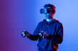 © Txema Gerardo/ADDICTIVE STOCK - Anonymous unshaven male in hoodie and modern goggles with controllers and extended arm experiencing virtual reality