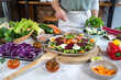 © The Trio Studio/ADDICTIVE STOCK - Crop anonymous female preparing delicious vegetable salad with sesame seeds at table in house kitchen