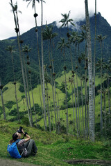 Wall Mural - Young girl photographer taking pictures of Cocora valley, Salento, Colombia, South America