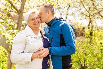 Man hugging his mother in the garden