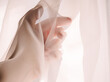 © Giovanna Graf - closeup of hand wrapped with transparent pink fabric