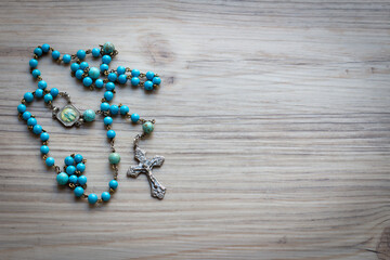 Wall Mural - Blue rosary on wood with copy space