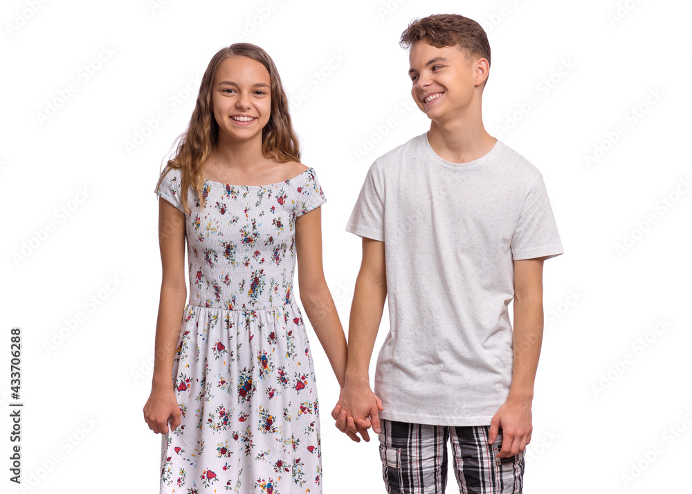 Portrait of smiling teen boy and girl holding hands together. Happy ...