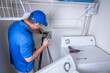 Washing machine appliance technician installing water supply lines